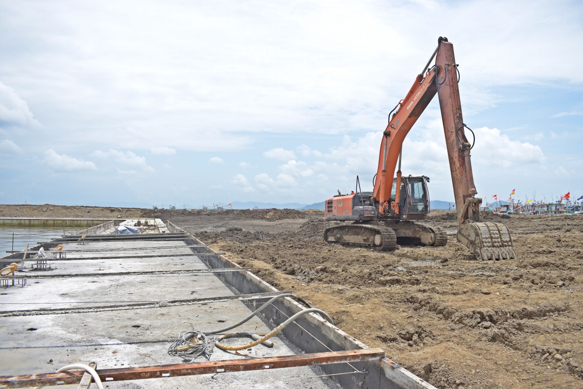 Orange excavator digger working on a construction site, illustrating asset finance for UK trades equipment.