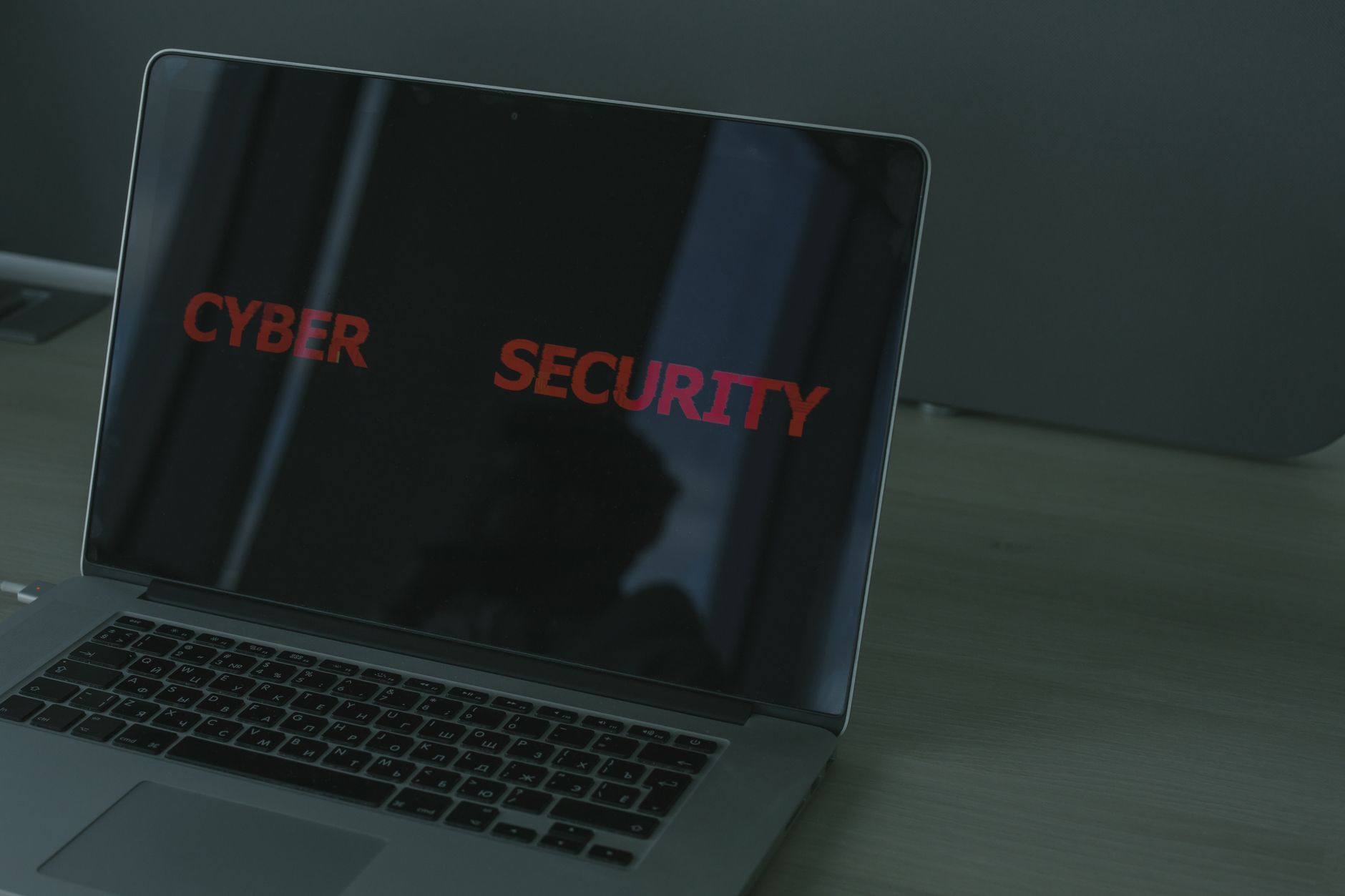 Laptop screen displaying 'CYBER SECURITY' in red text, illustrating Malwarebytes Microsoft Store SME security